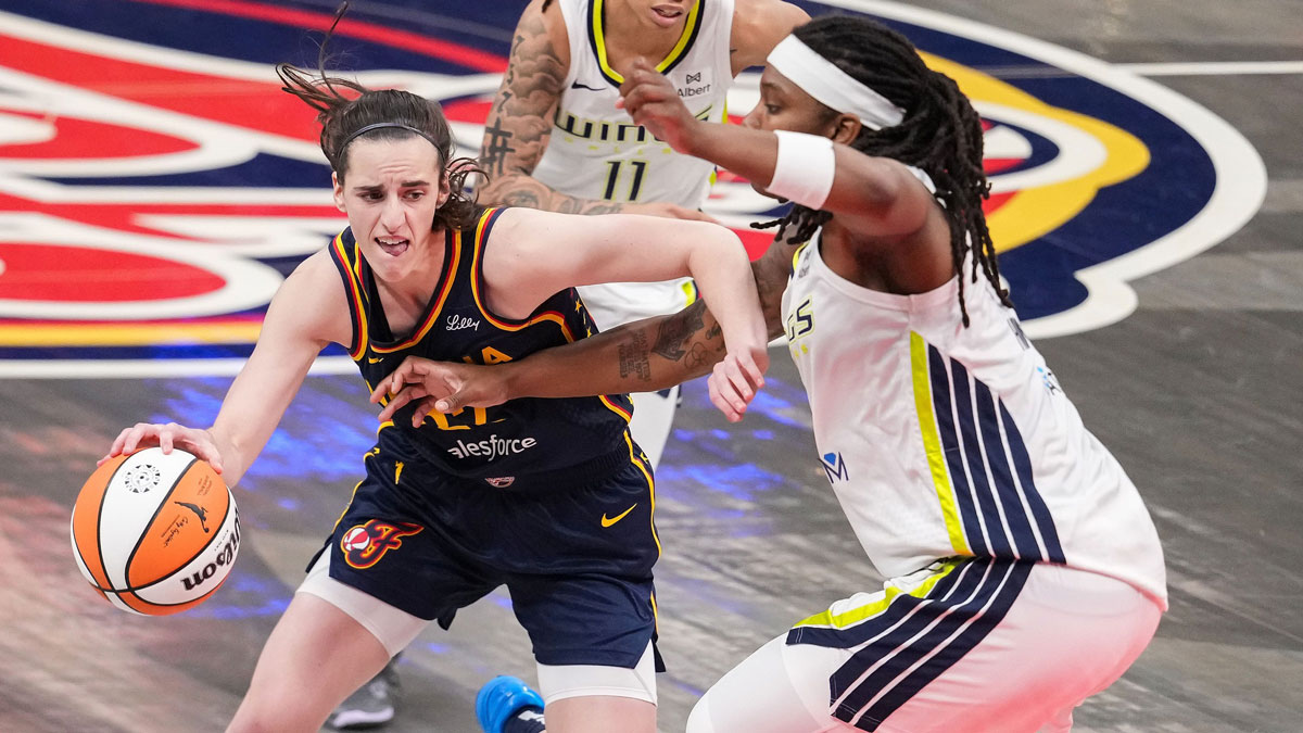 Indiana Fever guard Caitlin Clark (22) rushes up the court against Dallas Wings forward Myisha Hines-Allen (2) on Sunday, July 13, 2025, during the game at Gainbridge Fieldhouse in Indianapolis.