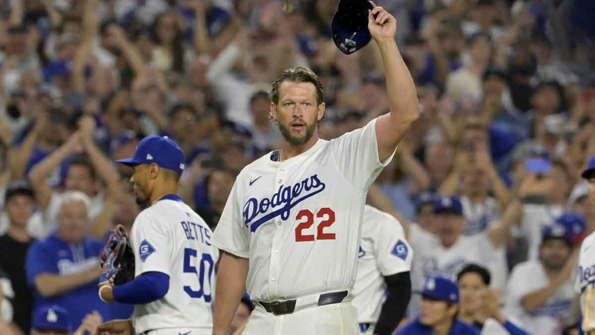 Los Angeles Dodgers starting pitcher Clayton Kershaw (22) acknowledges the crowd after striking out Chicago White Sox third baseman Vinny Capra (41) for his 3000th career strike in the fifth inning at Dodger Stadium.