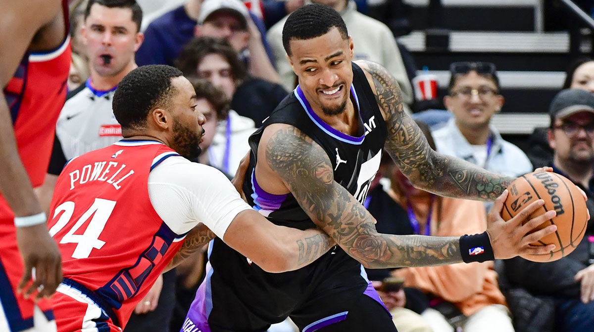 LA Clippers guard Norman Powell (24) defends Utah Jazz forward/center John Collins (20) during the second half at the Delta Center.