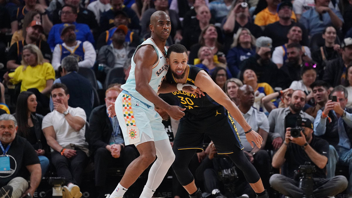 Warriors guard Stephen Curry (30) leans on San Antonio Spurs guard Chris Paul (3) in the second quarter at Chase Center