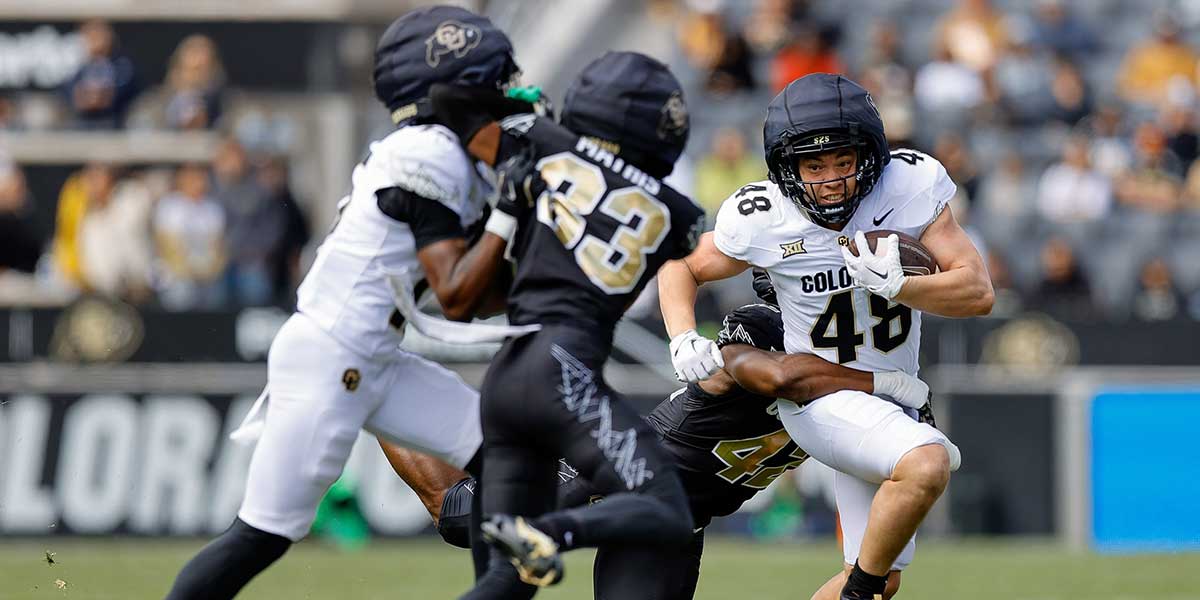 Colorado Buffaloes running back Christian Sarem (48) is tackled by inside linebacker Jeremiah Brown (42) as wide receiver Quentin Gibson (15) defends against cornerback Kole Mathis (33) during the spring game at Folsom Field.