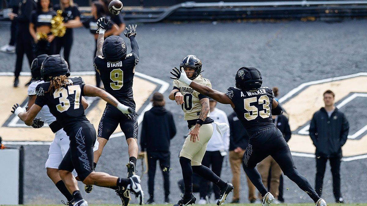 Colorado Buffaloes quarterback Julian Lewis (10) attempts a pass as safety Tawfiq Byard (9) and defensive end Arden Walker (53) and linebacker Martavius French (37) defend during the spring game at Folsom Field.