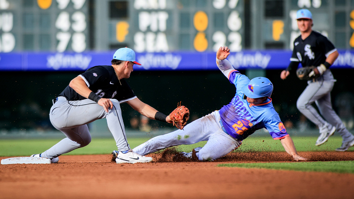 Jul 4, 2025; Denver, Colorado, USA; Colorado Rockies outfielder Mickey Moniak (22) slides into second base past an attempted tag by Chicago White Sox Colson Montgomery (12) at Coors Field.
