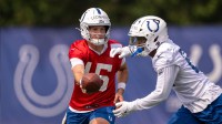 Indianapolis Colts quarterback Riley Leonard (15) hands the ball off during training camp at the Farm Bureau Football complex.