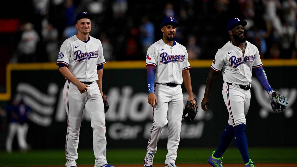 Texas Rangers shortstop Corey Seager (5) and second baseman Marcus Semien (2) and right fielder Adolis Garcia (53) come off the field after the win over the Baltimore Orioles at Globe Life Field.