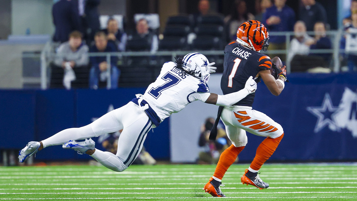 Cincinnati Bengals wide receiver Ja'Marr Chase (1) catches a pass as Dallas Cowboys cornerback Trevon Diggs (7) defends during the second half at AT&T Stadium.