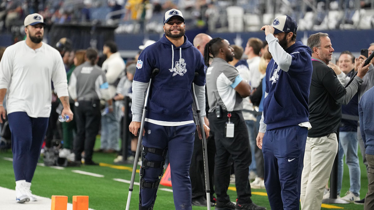 Dallas Cowboys quarterback Dak Prescott (left) stands on crutches before the game against the New York Giants at AT&T Stadium.