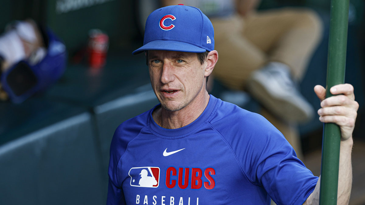 Chicago Cubs manager Craig Counsell (11) stands in the dugout before a baseball game against the Cleveland Guardians at Wrigley Field.