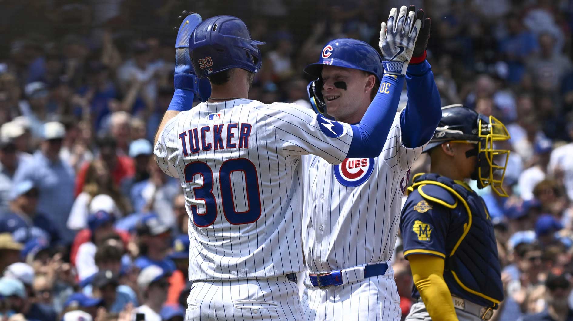 Jun 19 , 2025; Chicago, Illinois, USA; Chicago Cubs outfielder Pete Crow-Armstrong (4) high fives Kyle Tucker (30) after they score on his two-run home run against the Milwaukee Brewers during the first inning at Wrigley Field. Mandatory Credit: Matt Marton-Imagn Images