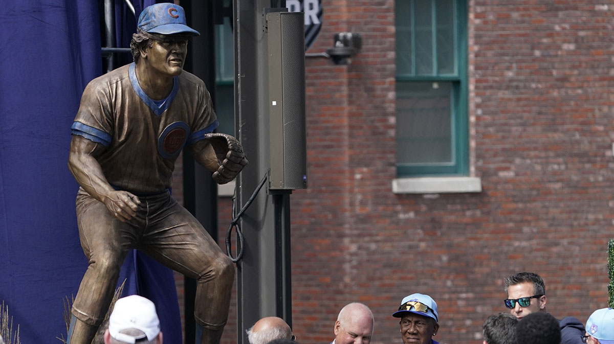 Ryne Sandberg (center) stands in front of his statue during the dedication ceremony before the game between the Chicago Cubs and the New York Mets at Wrigley Field.