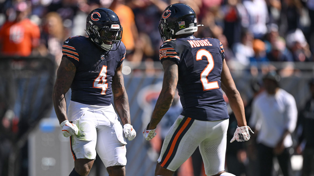 Chicago Bears running back D'Andre Swift (4) celebrates a long run with wide receiver DJ Moore (2) against the Carolina Panthers during the second quarter at Soldier Field.