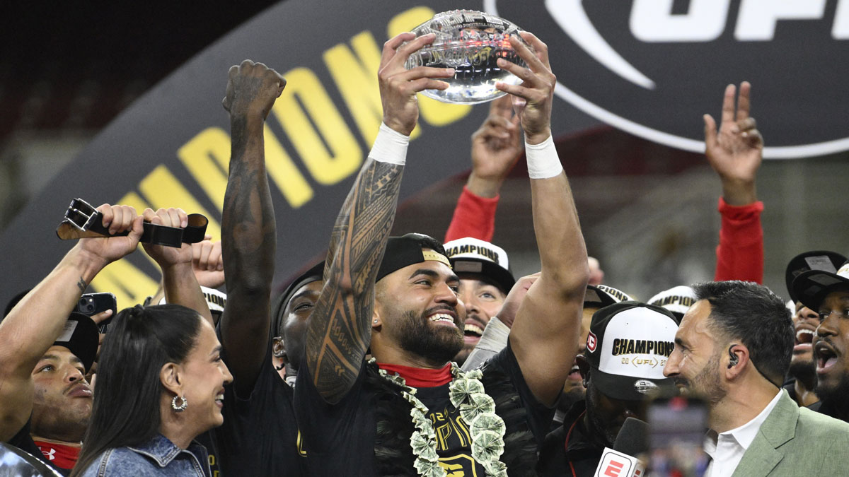 DC Defenders quarterback Jordan Ta'amu raises the UFL Championship MVP trophy after defeating the Michigan Panthers in the 2025 UFL Championship game at The Dome at America’s Center.