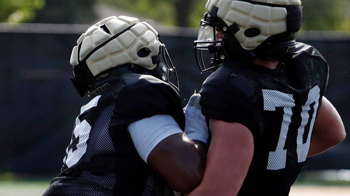 Purdue Boilermakers offensive lineman DJ Wingfield (55) and Purdue Boilermakers offensive lineman Max Parrott (70) run a drill