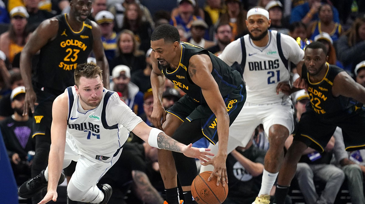 Dallas Mavericks guard Luka Doncic (77) loses control of the ball next to Golden State Warriors guard De'Anthony Melton (8) in the fourth quarter at the Chase Center.