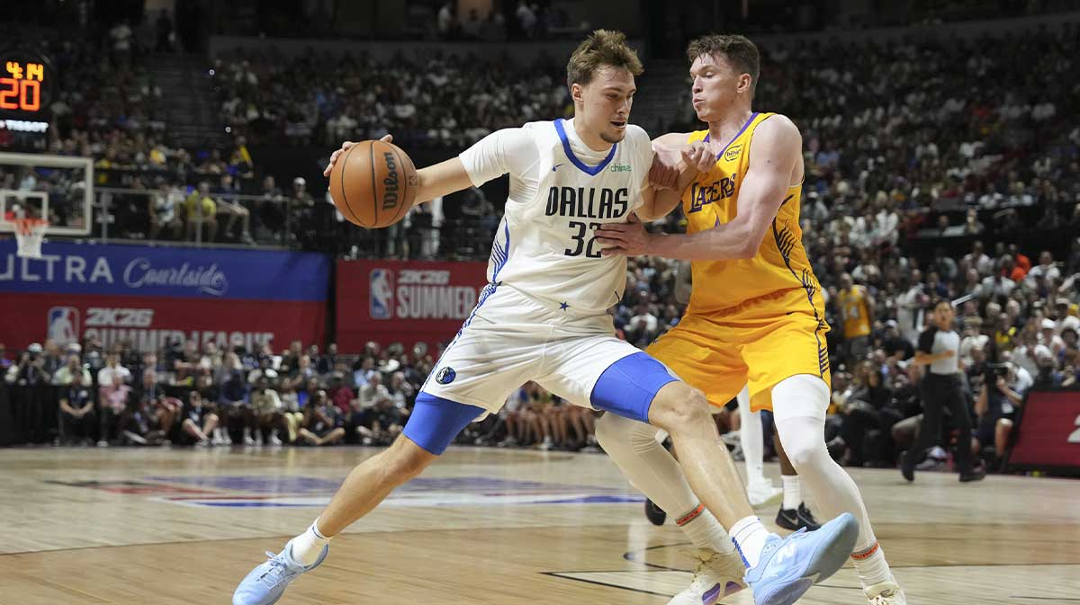 Dallas Mavericks forward Cooper Flagg (32) dribbles against Los Angeles Lakers guard Dalton Knecht (4) in the first quarter of their game at Thomas & Mack Center.