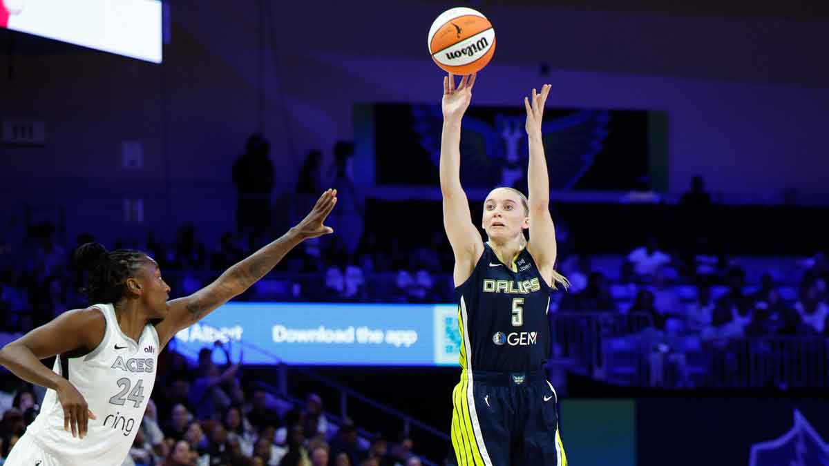 Dallas Wings guard Paige Bueckers (5) scores a three-point basket against Las Vegas Aces guard Jewell Loyd (24) during the second half at College Park Center.