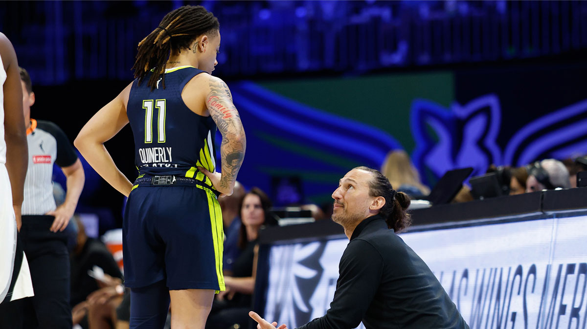 Dallas Wings head coach Chris Koclanes speaks with Dallas Wings guard JJ Quinerly (11) during a break in play against the Las Vegas Aces.