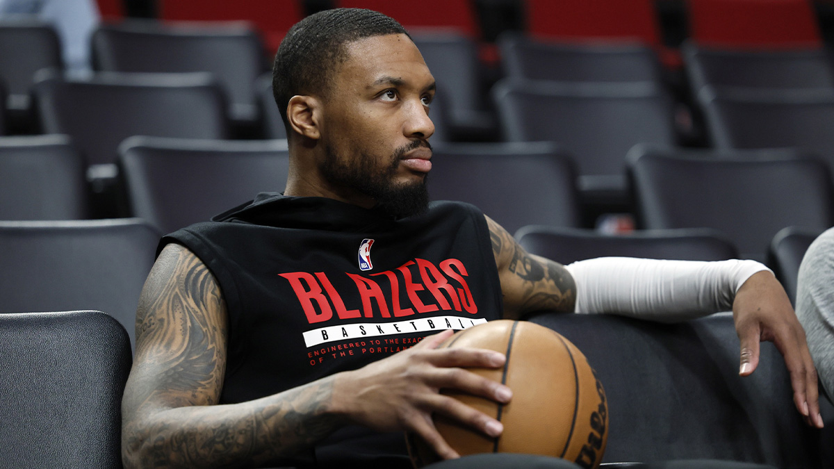 Portland Trail Blazers point guard Damian Lillard (0) watches players warm up prior to the game against the New Orleans Pelicans at Moda Center.