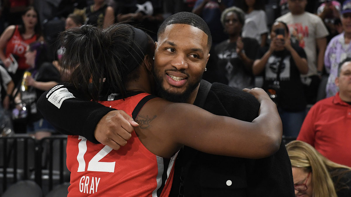 Las Vegas Aces guard Chelsea Gray (12) hugs NBA player Damian Lillard after her game against the Los Angeles Sparks at Michelob Ultra Arena.