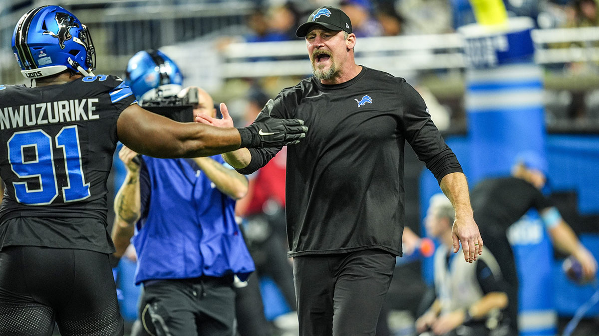 Detroit Lions head coach Dan Campbell greets players during warmups at Ford Field