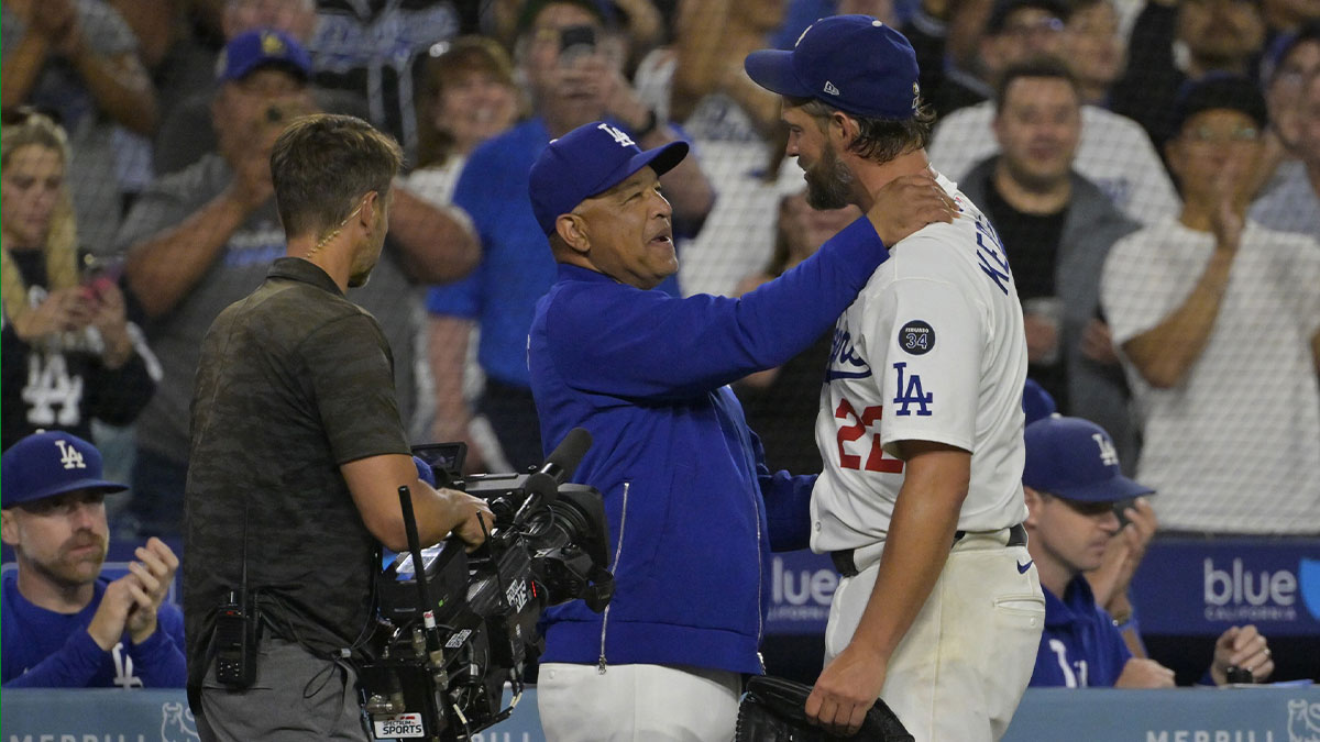 Los Angeles Dodgers manager Dave Roberts (30) congratulates starting pitcher Clayton Kershaw (22) after his 3000th career strikeout in the sixth inning against the Chicago White Sox at Dodger Stadium.