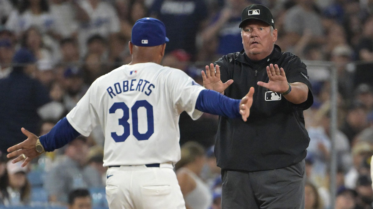 Los Angeles Dodgers manager Dave Roberts (30) is ejected by umpire Hunter Wendelstedt (21) after arguing an interference call by Los Angeles Dodgers shortstop Miguel Rojas (11) in the sixth inning against the Philadelphia Phillies at Dodger Stadium.