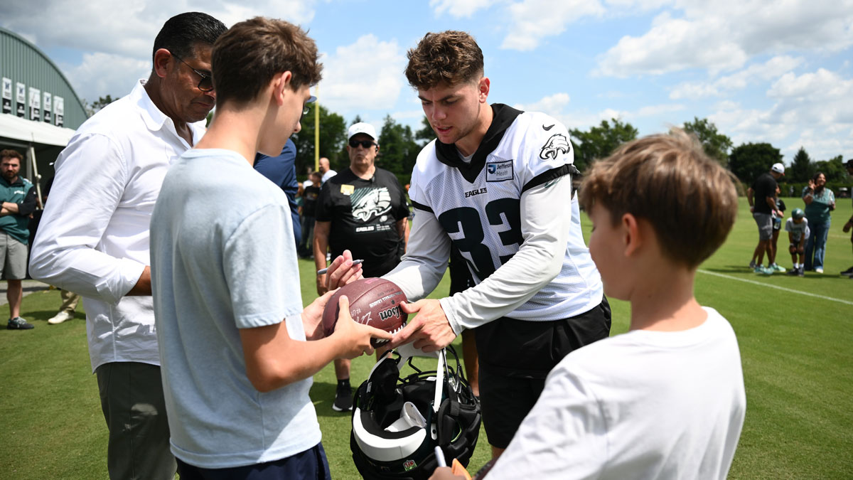 Philadelphia Eagles defensive back Cooper DeJean (33) signs autographs during training camp at NovaCare Complex.