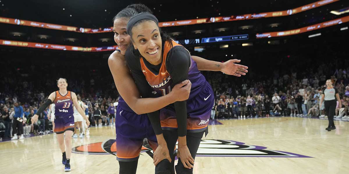 Phoenix Mercury forwards Alyssa Thomas (left) and DeWanna Bonner hug after beating the Minnesota Lynx 79-71 at PHX Arena on July 9, 2025. The teammates are engaged.