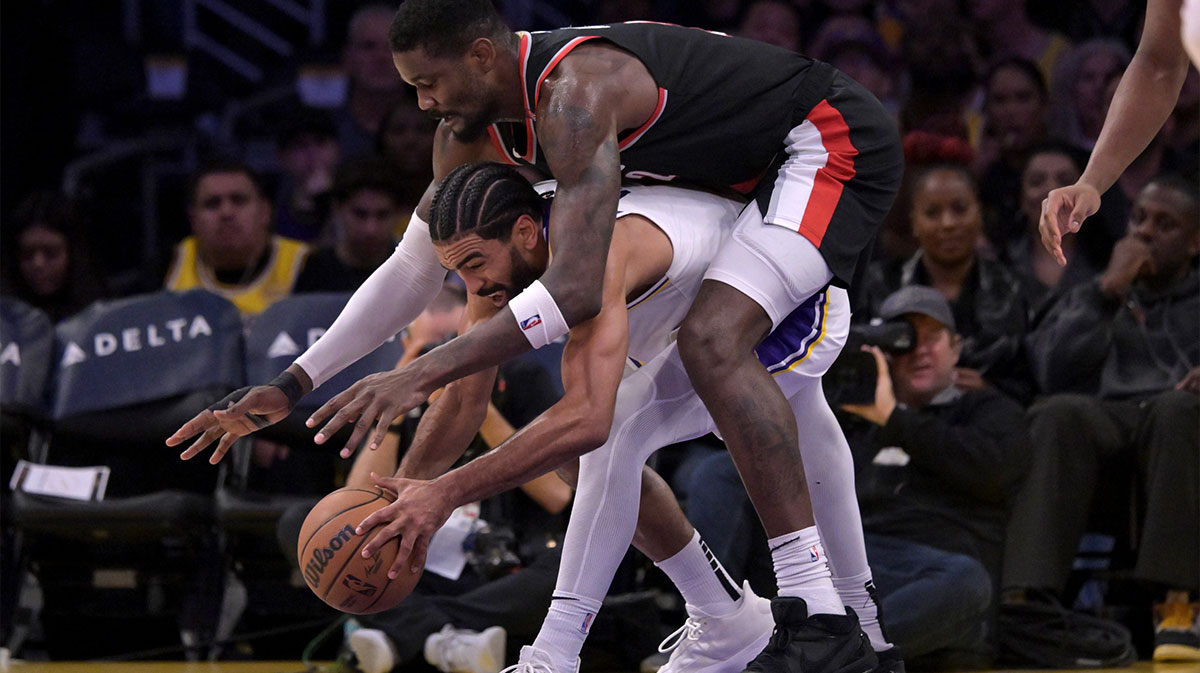 Portland Trail Blazers center Deandre Ayton (2) reaches over Los Angeles Lakers guard Gabe Vincent (7) for a loose ball in the second half at Crypto.com Arena.