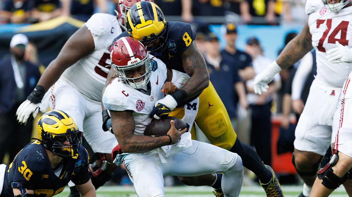 Michigan Wolverines defensive end Derrick Moore (8) sacks Alabama Crimson Tide quarterback Jalen Milroe (4) during the first half at Raymond James Stadium.