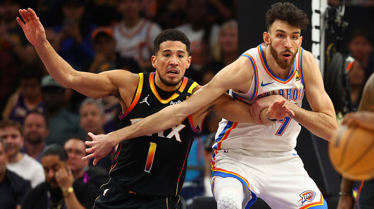 Phoenix Suns guard Devin Booker (1) and Oklahoma City Thunder forward Chet Holmgren (7) push for position during the first half at Footprint Center.