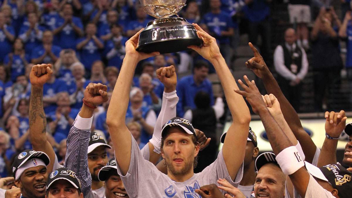 Dallas Mavericks forward Dirk Nowitzki (41) hoist the Western Conference champions trophy after game five against the Oklahoma City Thunder for the Western Conference Finals of the 2011 NBA playoffs at American Airlines Center. The Mavs beat the Thunder 100-96.