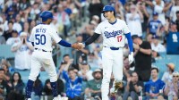 Los Angeles Dodgers designated hitter Shohei Ohtani (17) celebrates with Los Angeles Dodgers shortstop Mookie Betts (50) after scoring a run during the third inning against the Chicago White Sox at Dodger Stadium.