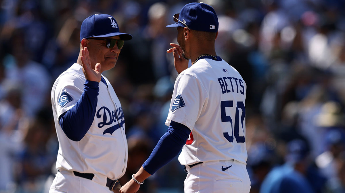 Los Angeles Dodgers manager Dave Roberts (30) and shortstop Mookie Betts (50) celebrate after defeating the New York Mets at Dodger Stadium.