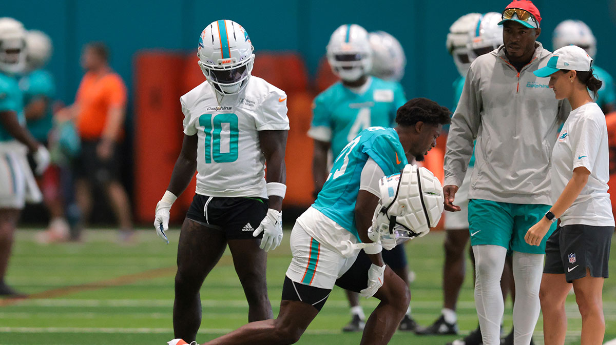 Miami Dolphins cornerback Artie Burns (23) reacts during training camp as wide receiver Tyreek Hill (10) watches at Baptist Health Training Complex.