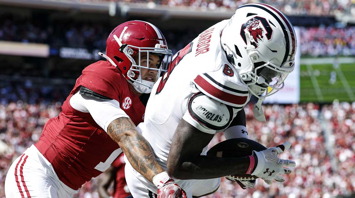 South Carolina Gamecocks wide receiver Nyck Harbor (8) catches a pass for a touchdown as Alabama Crimson Tide defensive back Domani Jackson (1) defends during the second half at Bryant-Denny Stadium.
