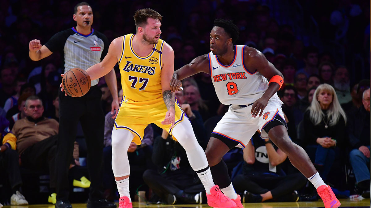 Los Angeles Lakers guard Luka Doncic (77) moves the ball against New York Knicks forward OG Anunoby (8) during the first half at Crypto.com Arena.