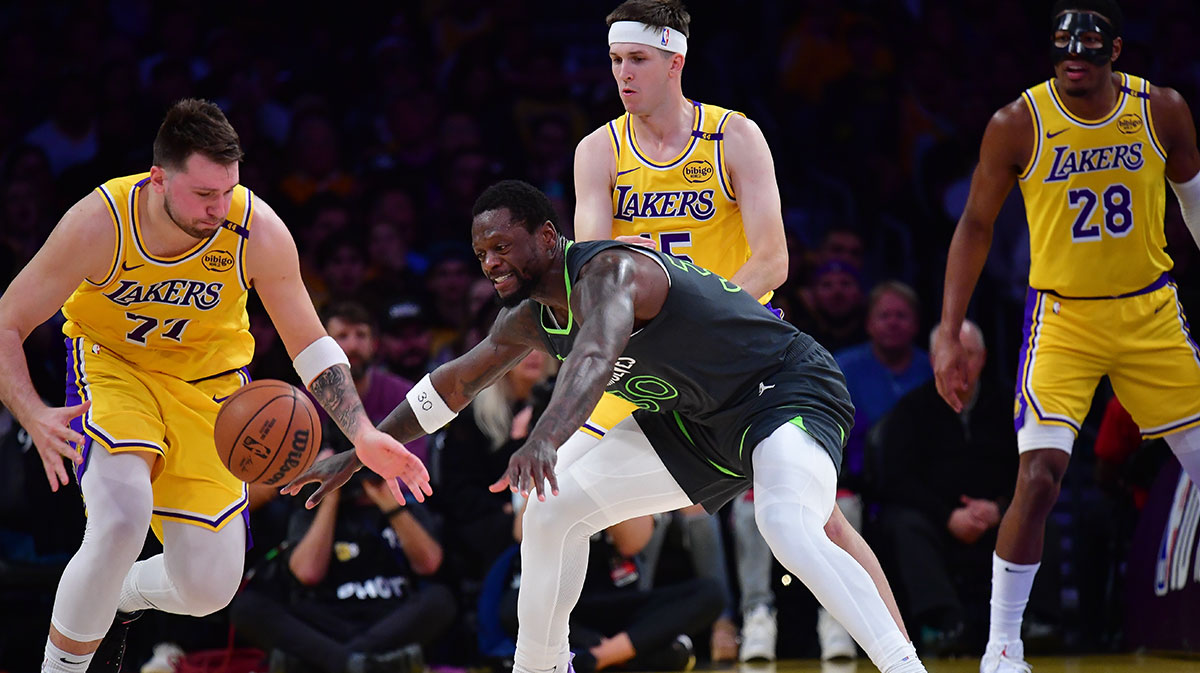 Los Angeles Lakers guard Luka Doncic (77) plays for the ball against Minnesota Timberwolves forward Julius Randle (30) during the first half in game five of first round for the 2025 NBA Playoffs at Crypto.com Arena.