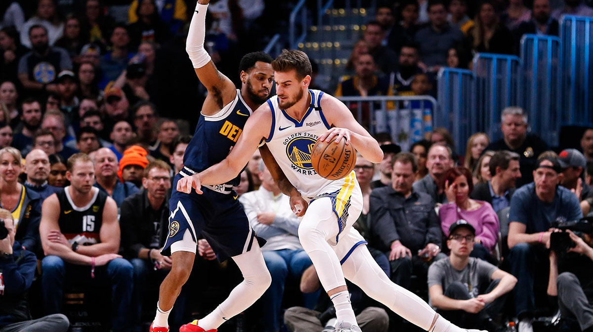 Golden State Warriors forward Dragan Bender (10) drives to the basket against Denver Nuggets guard Monte Morris (11) in the first quarter at the Pepsi Center. 