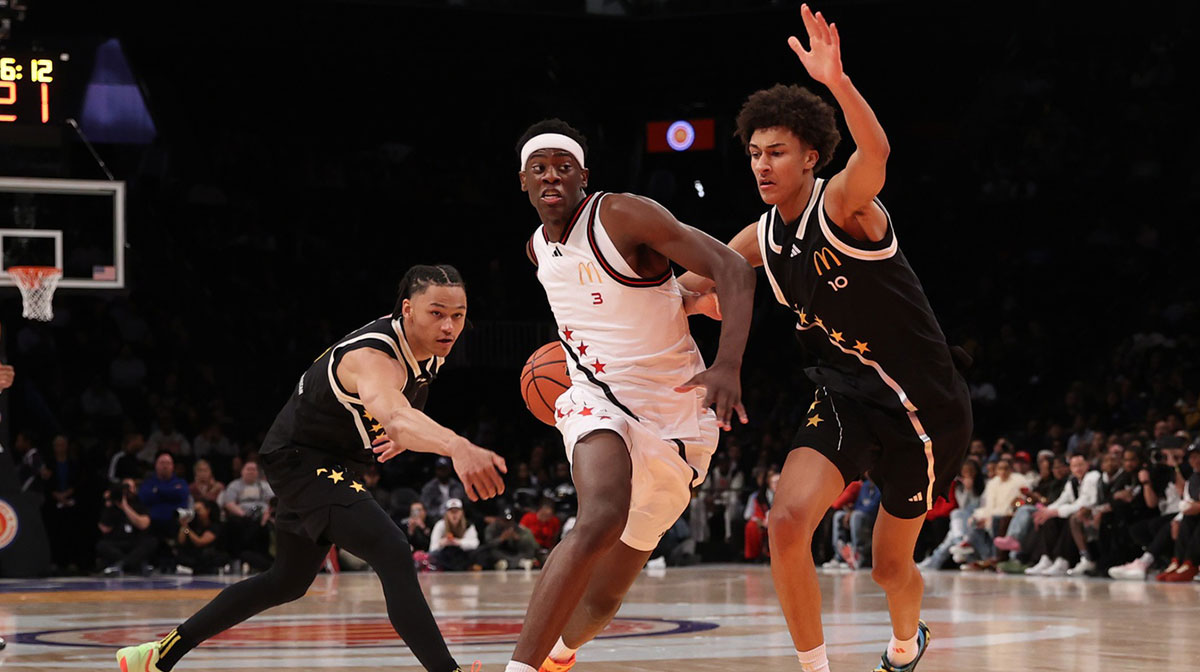 McDonald's All American West forward AJ Dybantsa (3) drives to the basket against McDonald's All American East guard Zai Harwell (0) and McDonald's All American East forward Nate Ament (10) during the first half of the game at Barclays Center.