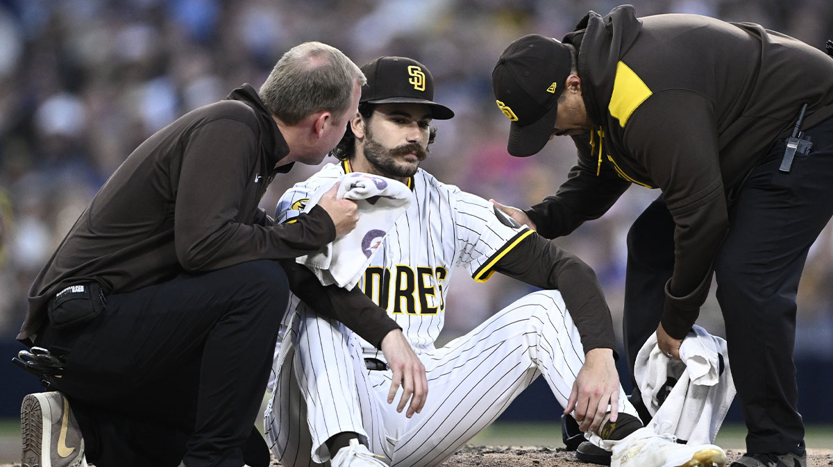 Trainers look at San Diego Padres starting pitcher Dylan Cease (84) after he was hit with a ball during the third inning against the New York Mets at Petco Park.