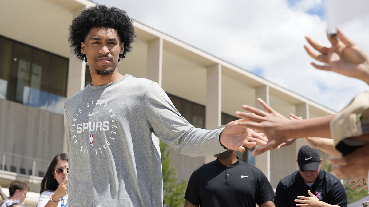 San Antonio Spurs first round draft pick Dylan Harper (2) greets fans at Victory Capital Performance Center.