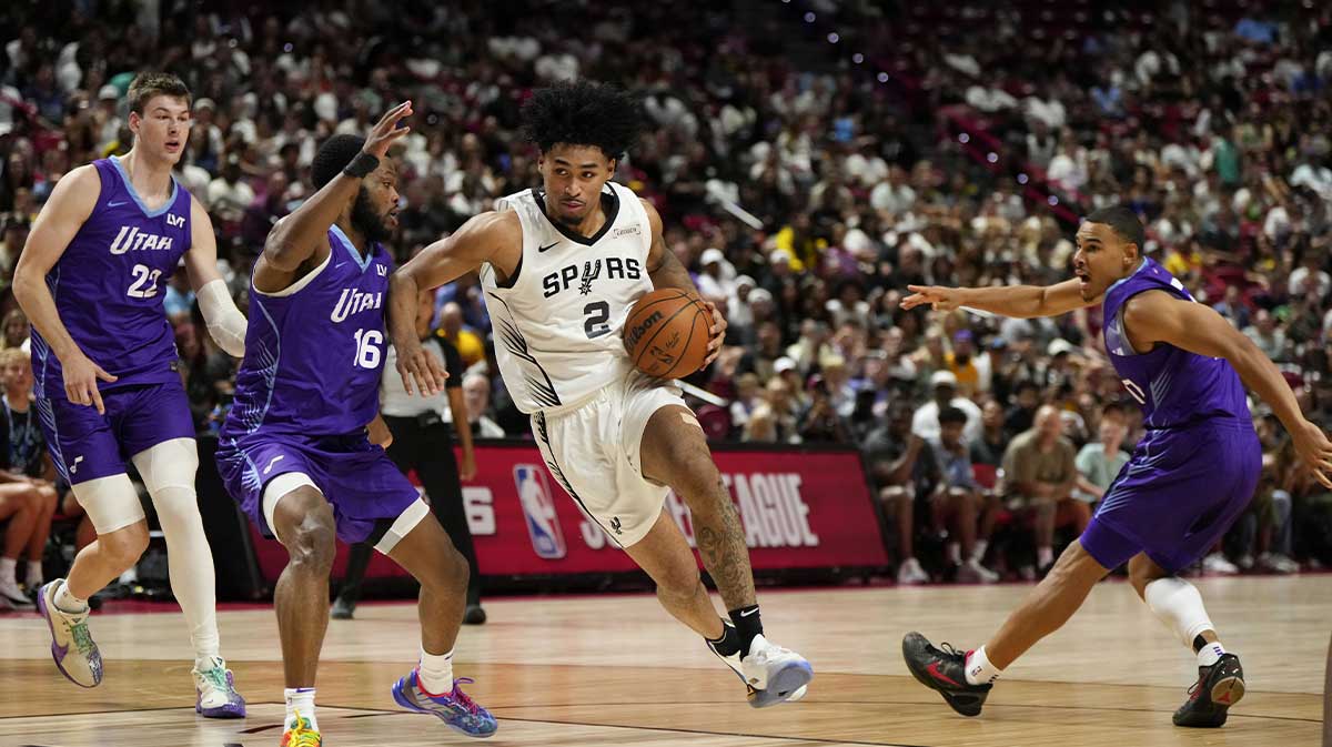 San Antonio Spurs guard Dylan Harper drives the ball past Utah Jazz guard Elijah Harkless (16) during the second half in a NBA basketball game at the Thomas & Mack Center.