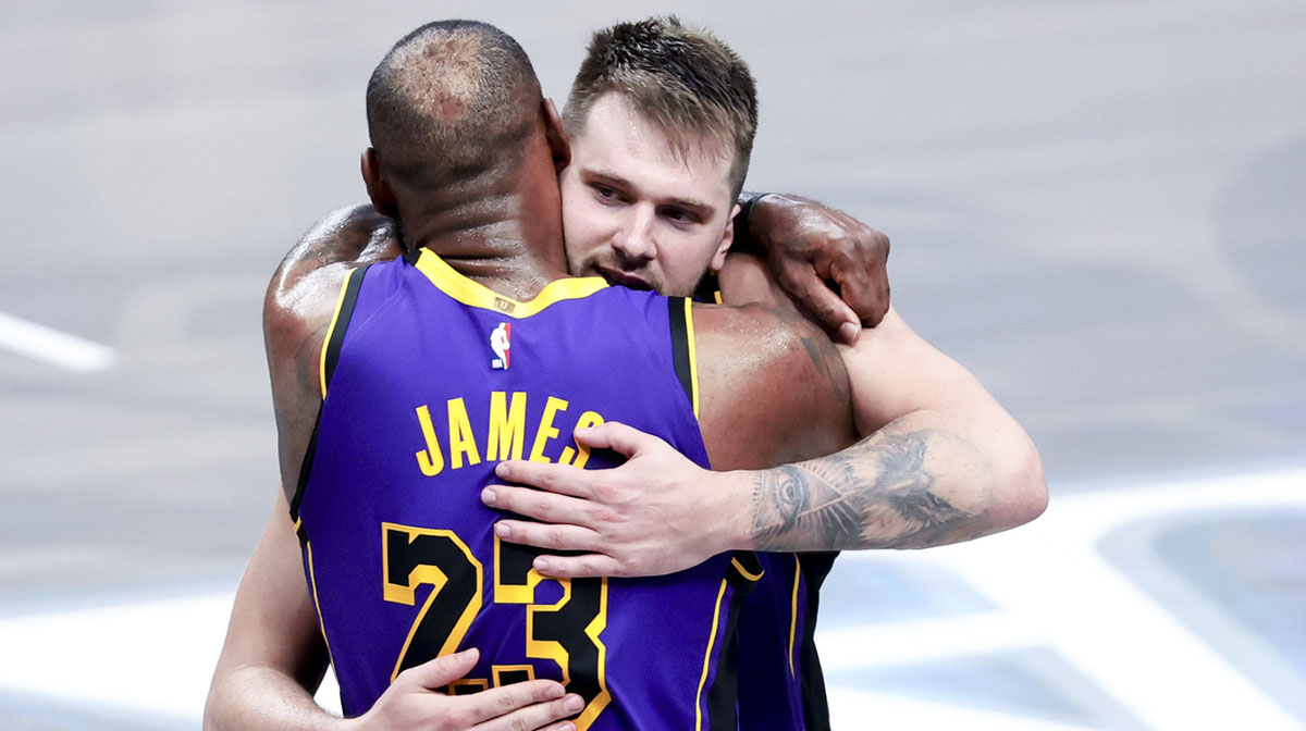 Los Angeles Lakers guard Luka Doncic (77) celebrates with Los Angeles Lakers forward LeBron James (23) during the fourth quarter against the Dallas Mavericks at American Airlines Center.
