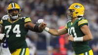 Green Bay Packers quarterback Jordan Love (10) reacts with guard Elgton Jenkins (74) during the second half for the 2024 NFC wild card game at AT&T Stadium.