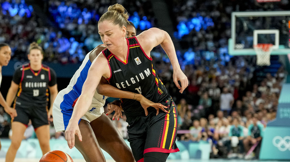 France small forward Valeriane Ayayi (11) and Belgium power forward Emma Meesseman (11) battle for the ball in a women's basketball semifinal game during the Paris 2024 Olympic Summer Games at Accor Arena.