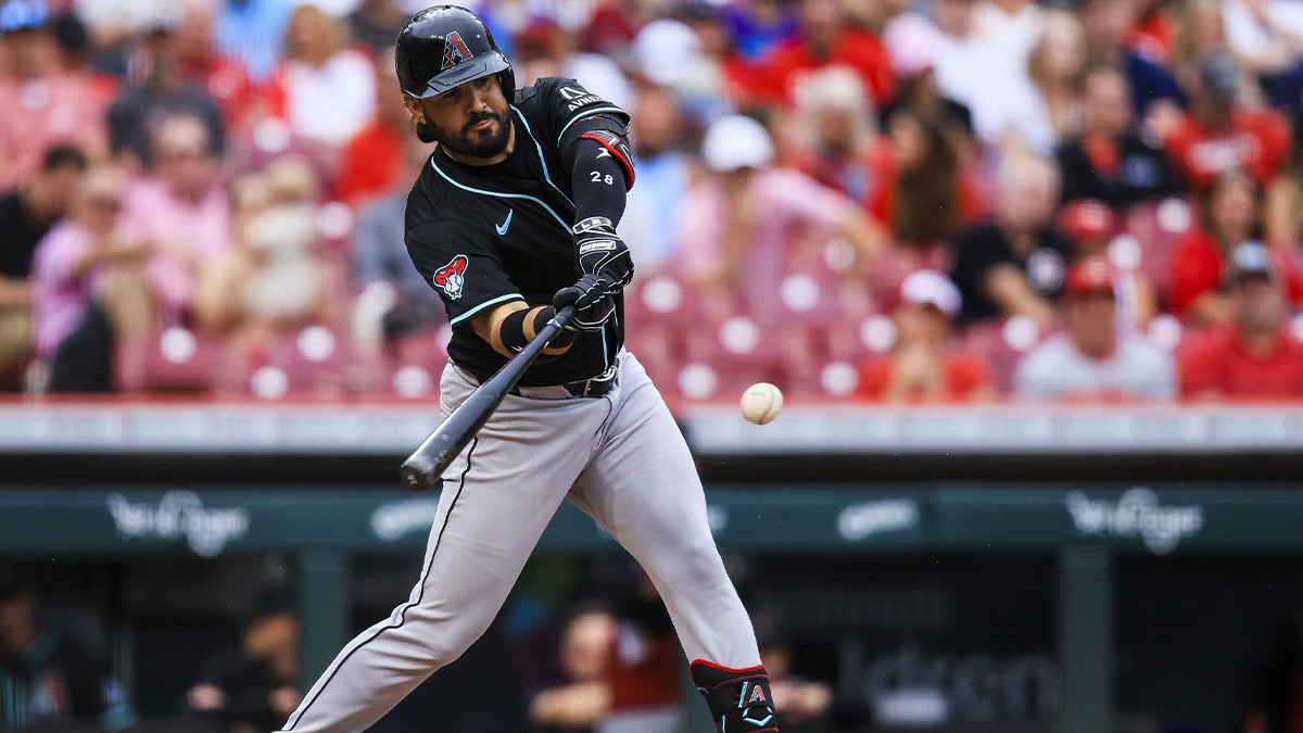 Jun 7, 2025; Cincinnati, Ohio, USA; Arizona Diamondbacks third baseman Eugenio Suarez (28) hits a single in the eighth inning against the Cincinnati Reds at Great American Ball Park.