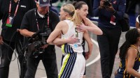 Fever guard Caitlin Clark and Wings' Paige Bueckers hugging
