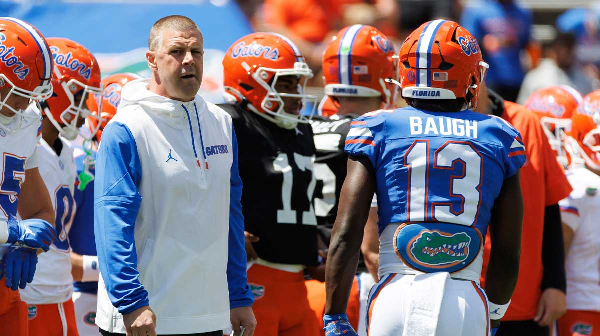 Florida Gators head coach Billy Napier looks on while Florida Gators running back Jadan Baugh (13) walks by before the game at Ben Hill Griffin Stadium.
