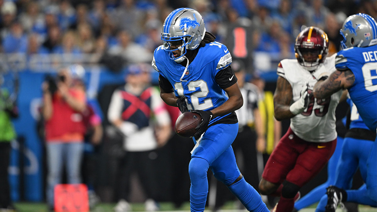 Detroit Lions quarterback Teddy Bridgewater (12) hands the ball off during the second quarter against the Washington Commanders in a 2025 NFC divisional round game at Ford Field.